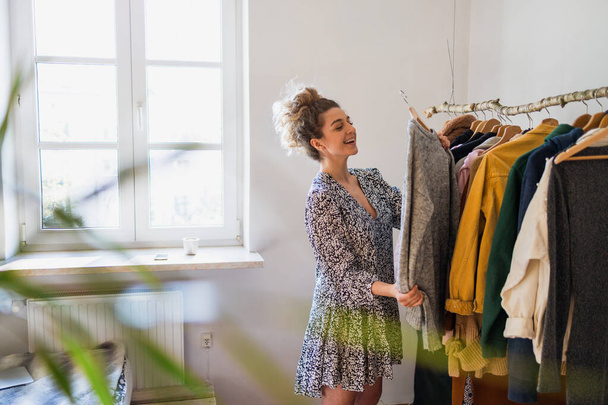 Young woman choosing clothes - Foto, immagini