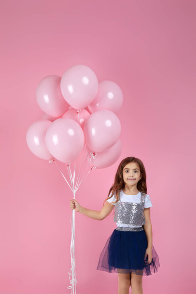 child girl posing with pastel pink air balloons - Foto, afbeelding