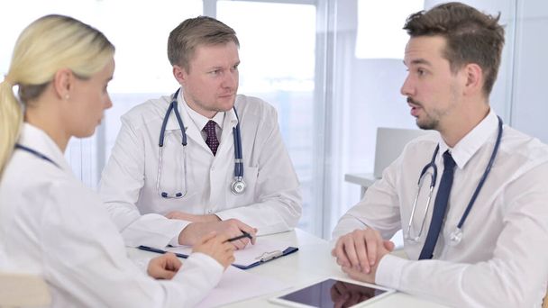 Senior Doctor Talking with Doctors in Meeting - Photo, Image