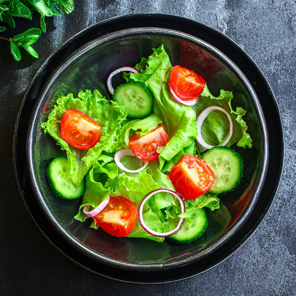 Healthy salad, leaves mix salad (mix micro greens, cucumber, tomato, onion, other ingredients). food background. copy space for text keto or paleo diet - Photo, Image
