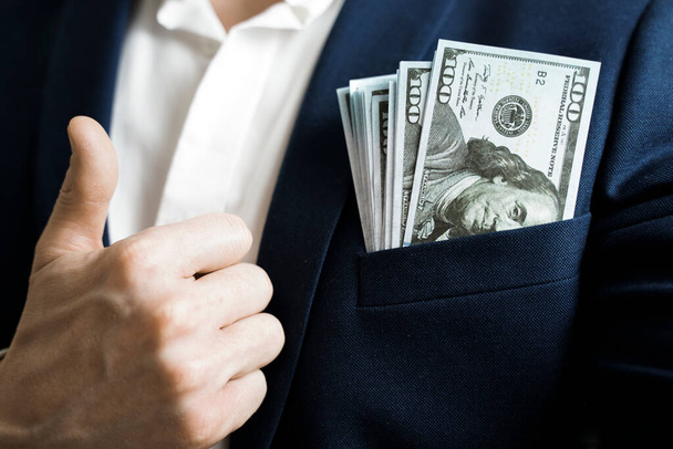 Money success concept. 100 dollar bills in businessman jacket pocket. Symbol of success and wealth. - Foto, Imagem