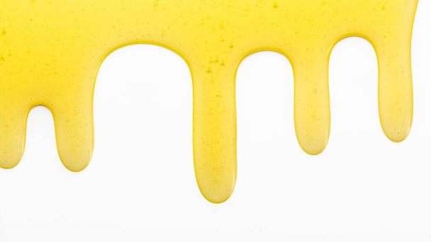 drips of honey on a white background, copy space - Fotografie, Obrázek