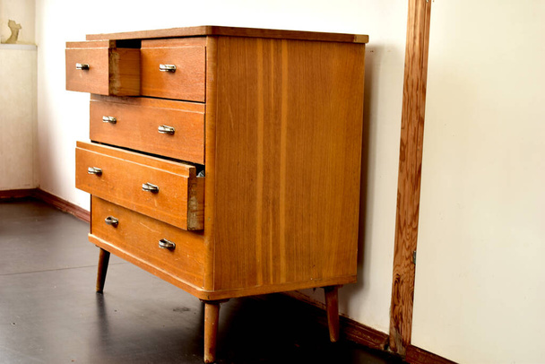 Old wooden chest of drawers with shiny handles. - Photo, Image