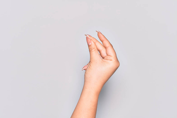 Hand of caucasian young woman snapping fingers for success, easy and click symbol gesture with hand - Фото, изображение