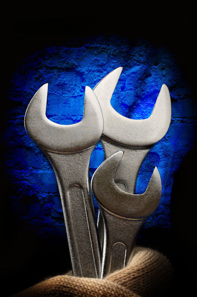 Metallic wrenches in male hand - Photo, Image