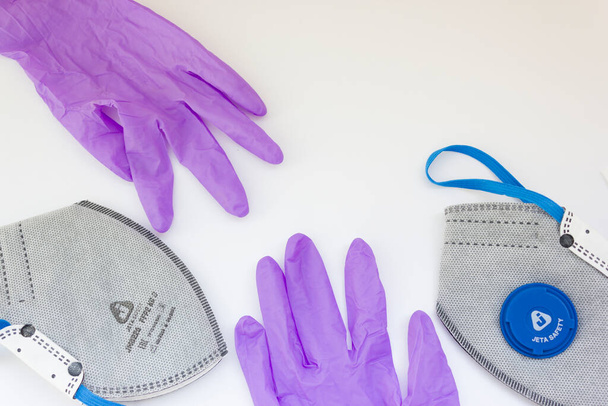 Coronavirus personal protective equipment concept with copy space. Medical latex gloves, goggles, ffp2 respirator, antibacterial gel.coronavirus flatly. - Photo, Image