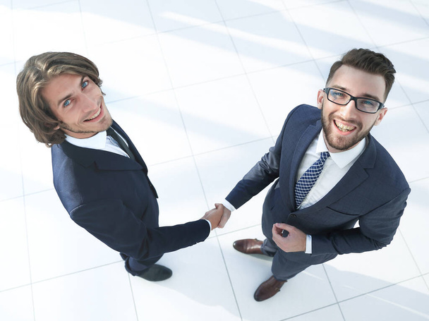 Businesswoman and businessman shaking hands in office, - Foto, immagini