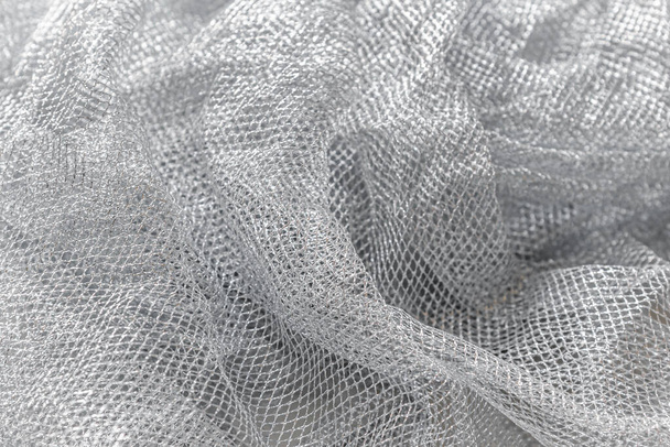 abstract background of silver mesh fabric close up - Fotografie, Obrázek