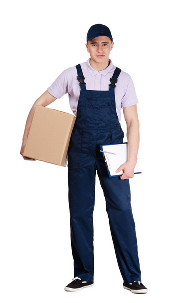 Young delivery man in overalls hands parcel box - Fotó, kép