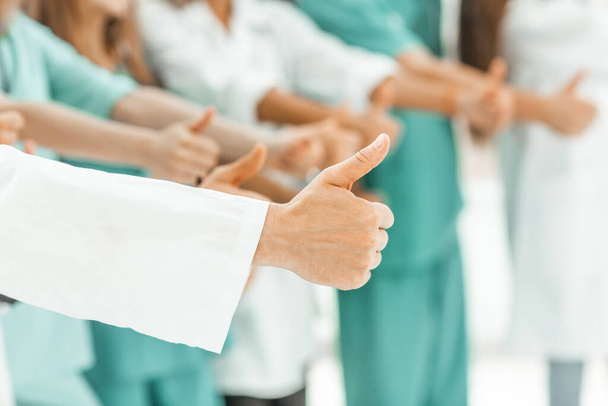 close up. group of doctors showing thumbs up. - Φωτογραφία, εικόνα