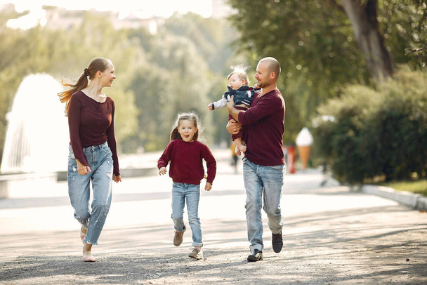 Family with cute kids in a autumn park - Foto, immagini