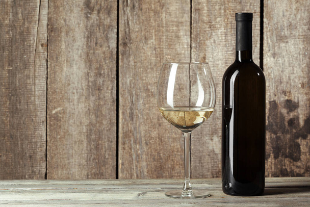 Wine bottles with glass, wooden background. Close up. - Φωτογραφία, εικόνα