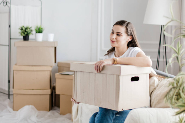 close up. happy young woman with a large cardboard box - Photo, Image