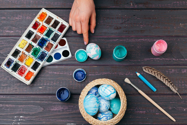 Female hands painting Easter eggs. Close up. - Fotó, kép