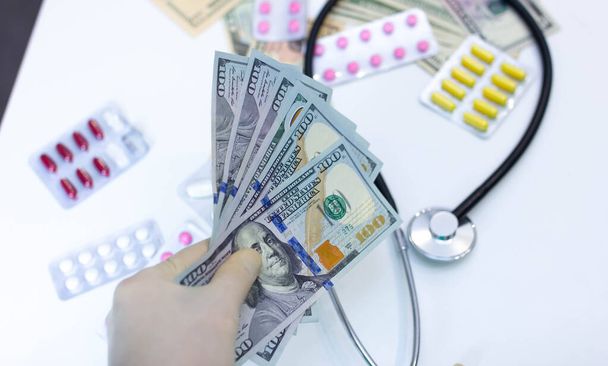 medicines and pills with dollars money, pharmaceutical drugs price hike concept - Foto, imagen