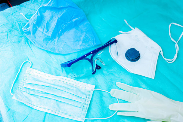 gloves, mask, glasses and a medical uniform. pandemic virus protection. - Zdjęcie, obraz