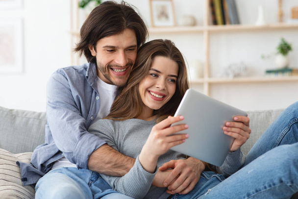 Κοντινό πορτρέτο του ευτυχισμένου ζευγαριού που χρησιμοποιεί ψηφιακή ταμπλέτα μαζί - Φωτογραφία, εικόνα