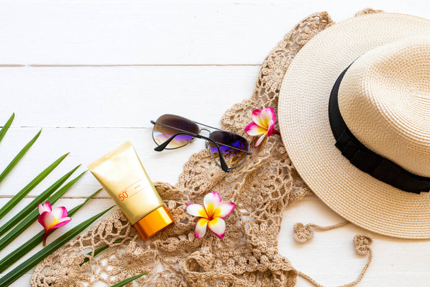 sunscreen spf50  cosmetics health care for skin face with crochet ,flowers frangipani ,sunglasses ,hat and coconut leaf of lifestyle woman relax in summer arrangement flat lay style on white - Fotografie, Obrázek