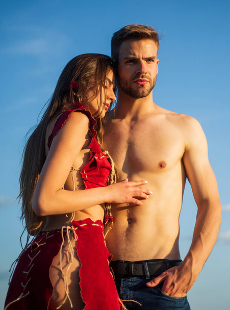 I love you. sexy couple in love. tribal fashion. woman in suede leather clothes. handsome man with bare torso. muscular guy and slim girl. summer holiday and vacation. wild and dangerous love - 写真・画像