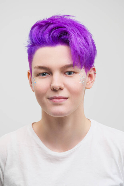 Portrait of a young attractive woman in a white T-shirt on a white background. Purple-colored short hair. - Φωτογραφία, εικόνα