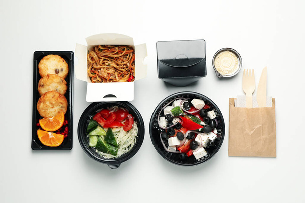 Food delivery. Food in take away boxes on white background - Photo, Image
