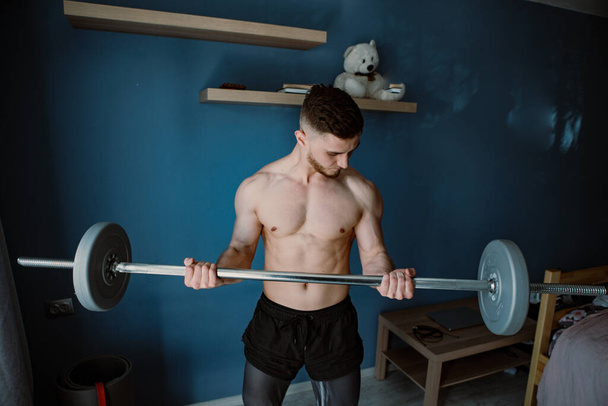 guy exercising with barbell at home - Fotografie, Obrázek