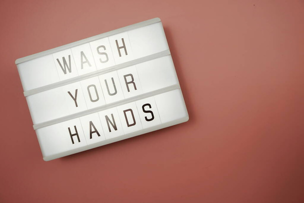 Flat lay Wash Your Hands word in light box with space coy on pink background - Фото, зображення