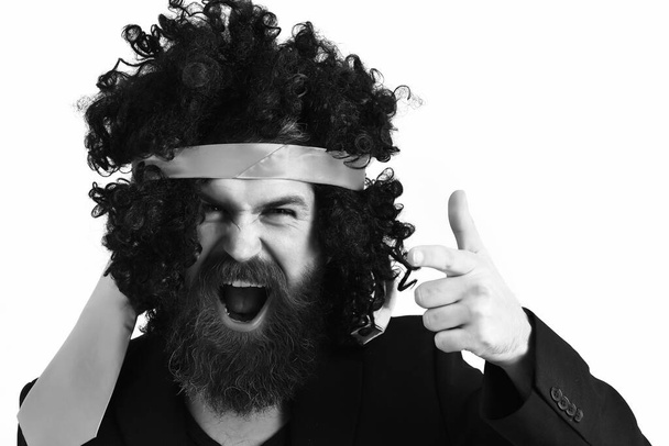 caucasian hipster in suit and black curly tie-tied afro wig - Valokuva, kuva