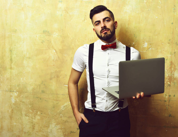 Manager with beard and confident face expression holding laptop - Photo, image