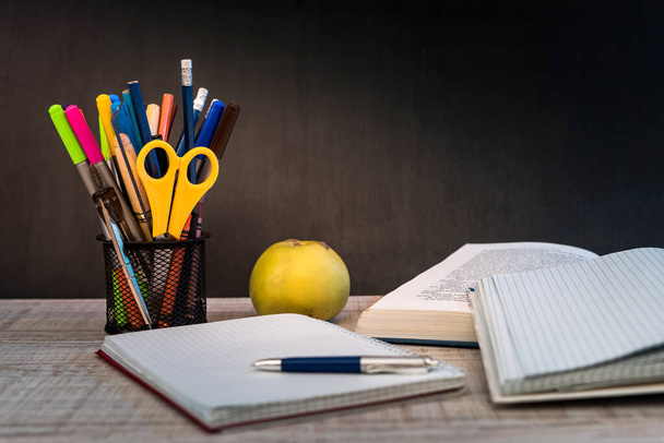 empty notepad on teacher desk against  chalkboard. education concept. - Photo, Image