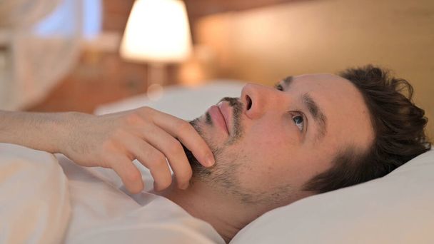 Ambitious Young Man Thinking in Bed - Foto, imagen