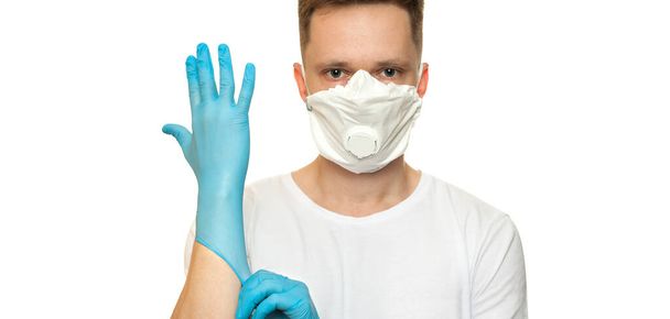 Young surgeon doctor in latex protective gloves in white protection mask on white background. Man in medical gloves and on protective face mask. Coronavirus COVID-19 protectio - Foto, immagini