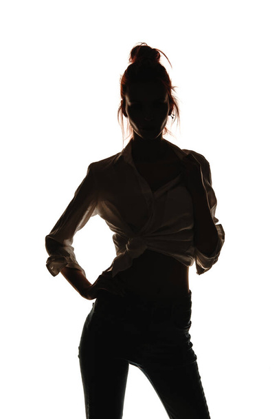 Portrait of a female model posing in trendy denim pants and stylish shirt - Foto, Imagem