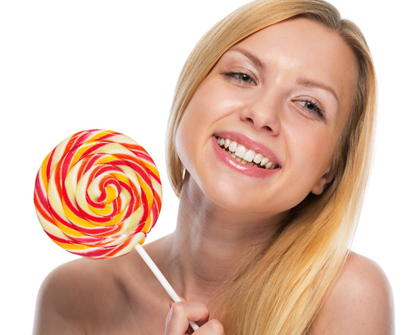 Portrait of happy teenage girl holding lollypop - Fotó, kép