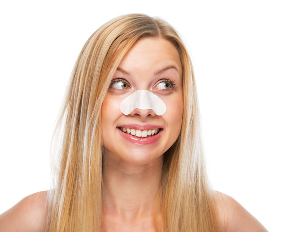 Smiling teenage girl with clear-up strips on nose looking on copy space - Photo, Image