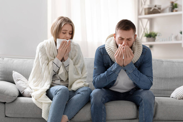 Sick man and woman coughing at home interior - Photo, Image