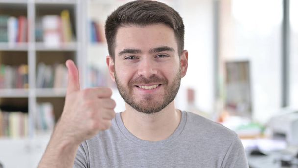 Portrait of Thumbs up by Positive Young Man - Fotografie, Obrázek