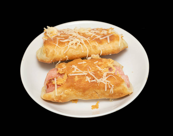 Fried pies with sausage and cheese on a plate. - Photo, Image