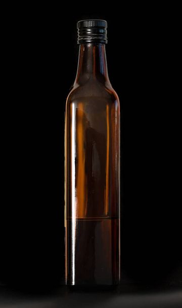 Glass bottle isolated on a black background. - Foto, afbeelding