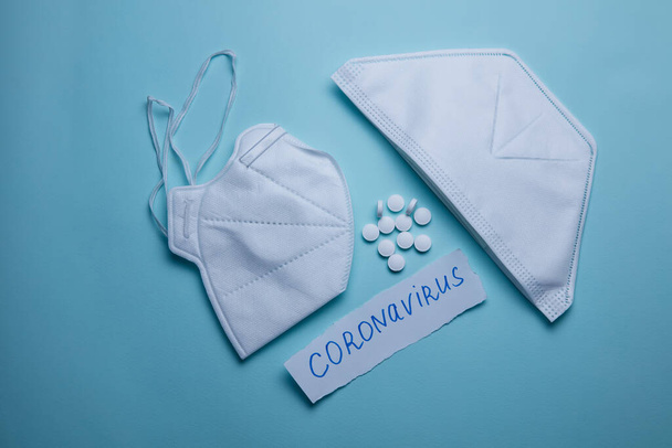 pills and protective mask on a blue background. Concept of medicine. Prevention of coronavirus. - Φωτογραφία, εικόνα