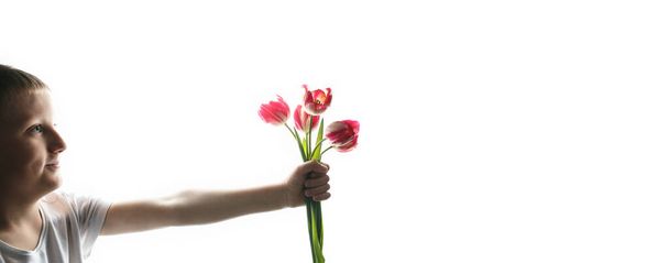 Child with bouquet of tulips on white background. - Foto, imagen