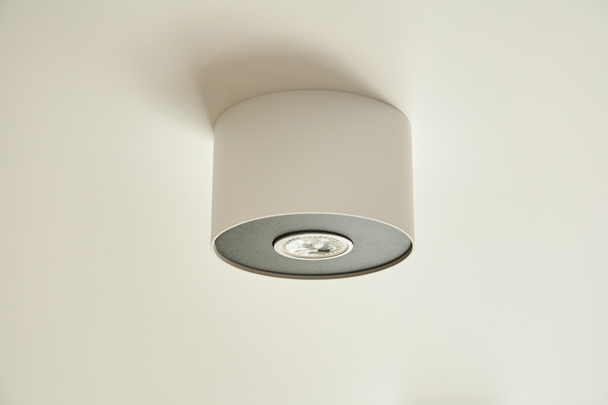 halogen light bulb in lamp on white ceiling in apartment  - Photo, Image