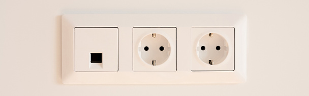 panoramic orientation of switch near power sockets on white  - Photo, Image