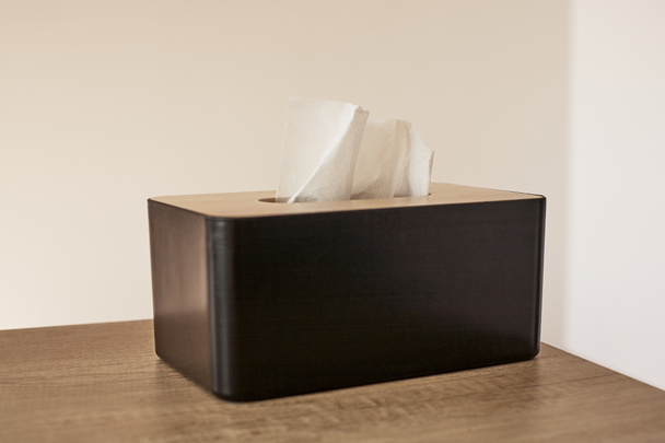 tissue box with white napkin on wooden table  - Zdjęcie, obraz