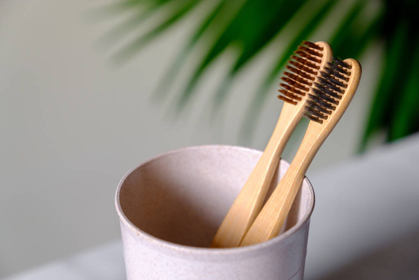 Natural organic bamboo toothbrushes in cup, close up view. Dental care concept. - Foto, immagini