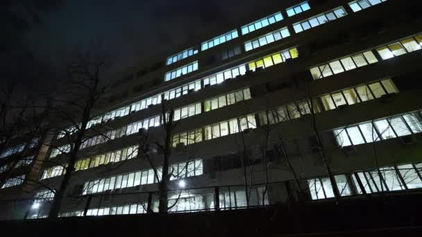 Office building at night. Exterior of an office building with lighted windows in the late evening. Campus. IT company. Modern business center, outside view. - Footage, Video