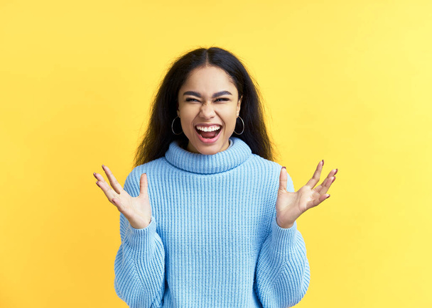 Happy excited black woman celebrate success isolated on yellow background. Victory, emotions concept - Foto, immagini