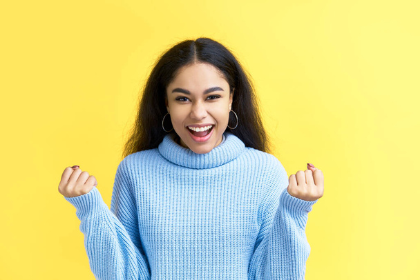 Happy excited black woman celebrate success isolated on yellow background. Victory, emotions concept - Fotografie, Obrázek