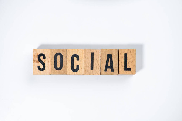 " SOCIAL " text made of wooden cube on  White background. - Zdjęcie, obraz