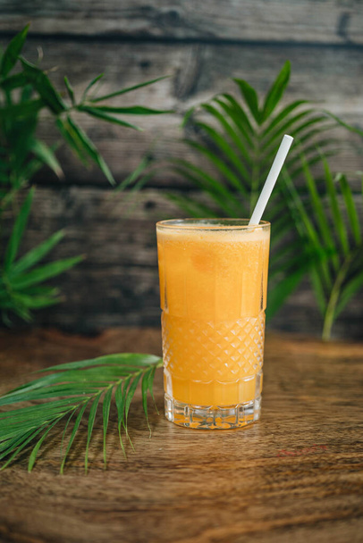 Orange juice on table on wooden background - Fotografie, Obrázek